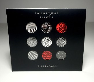 Album cover designer, Brandon Rike, gives a face to the character Blurryface by combining the elements of Twenty One Pilots as a band, but also what the album brings (Brandon RIke, web, http://brandonrike.com/behind-blurryface